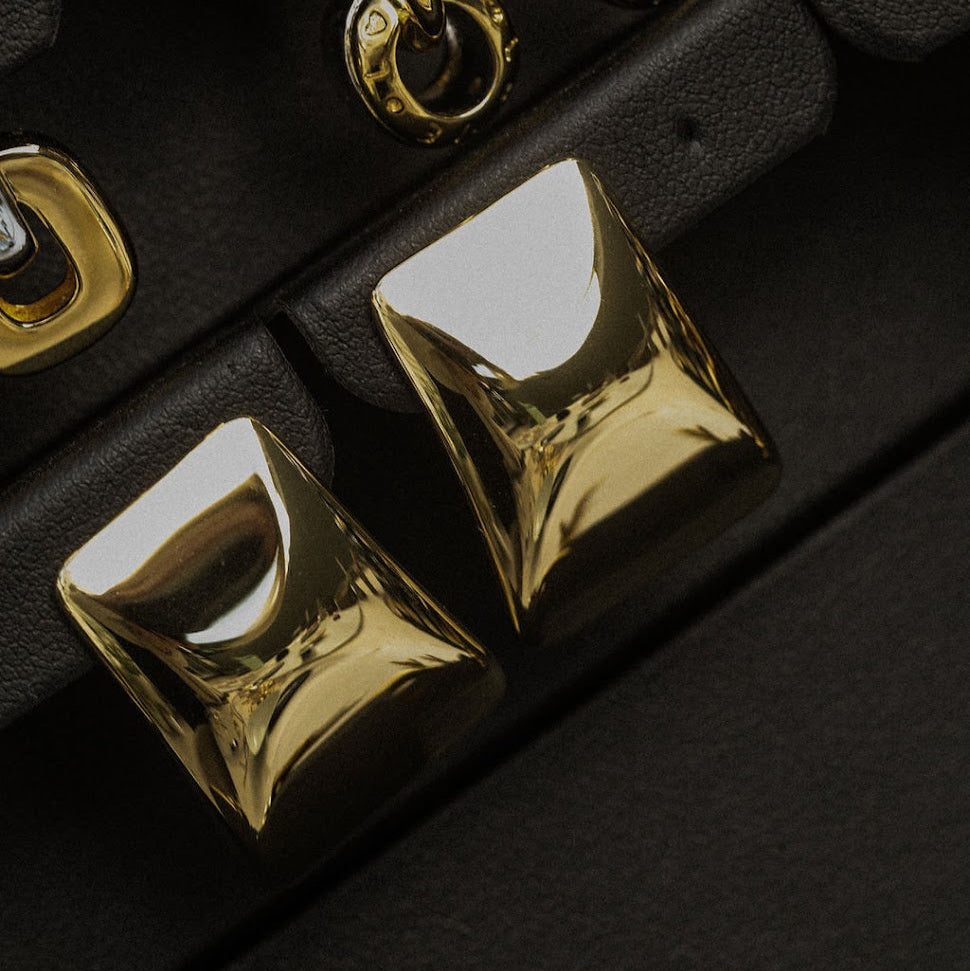 Gold earring set on a black background