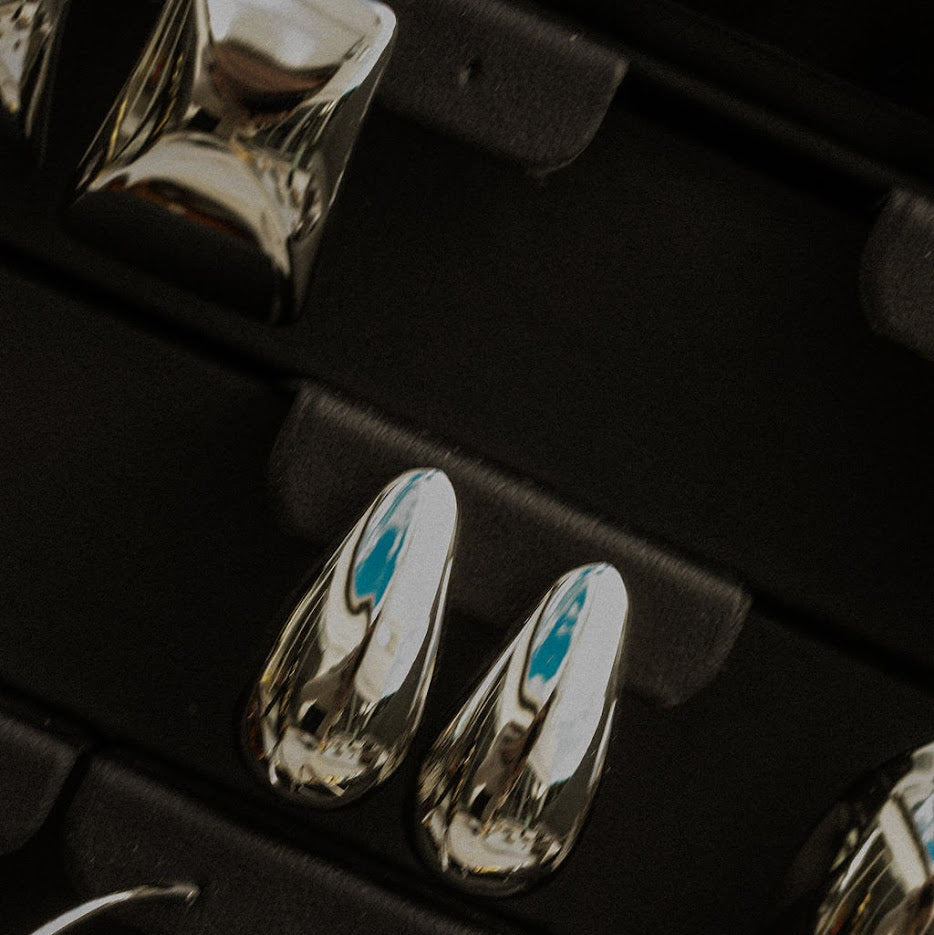 Silver earrings in a black jewelry box