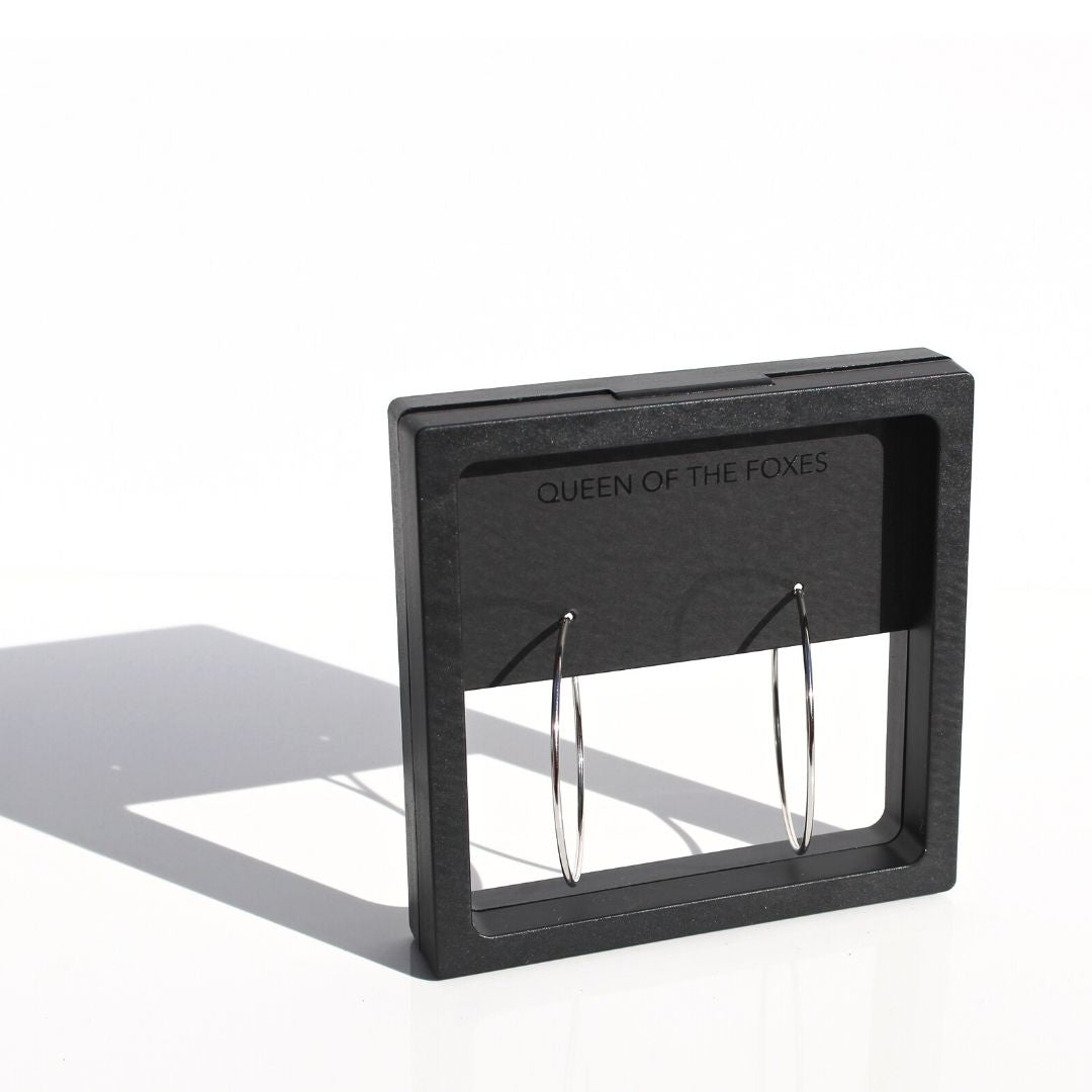 Fine silver hoop earrings displayed in black Queen of the Foxes presentation packaging.