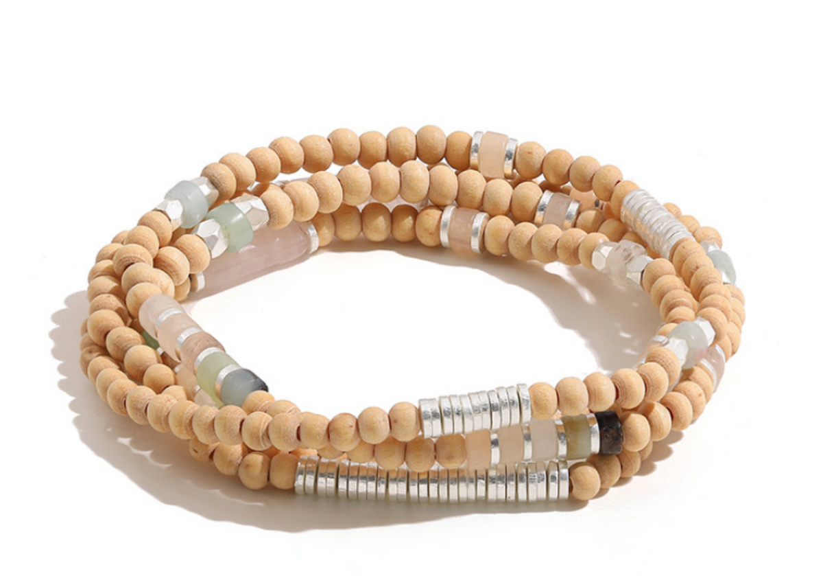 Natural Wood Wrap bracelet with pale wooden beads, blush-pink and sage accents, and silver-tone disc spacers, coiled on white.