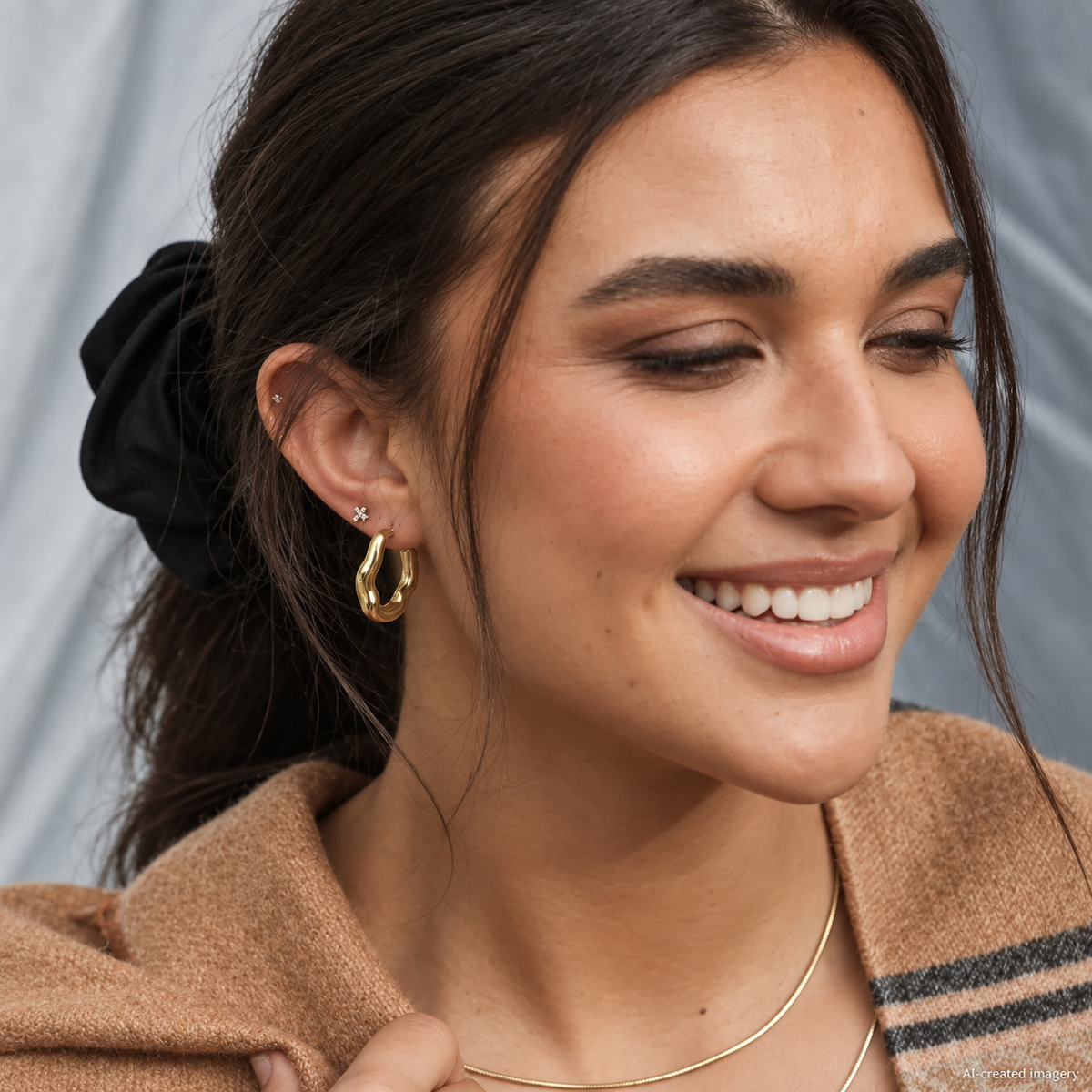 AI-edited side view of a brunette wearing a gold Organic Hoop Earring, with her hair tied back and a brown scarf.