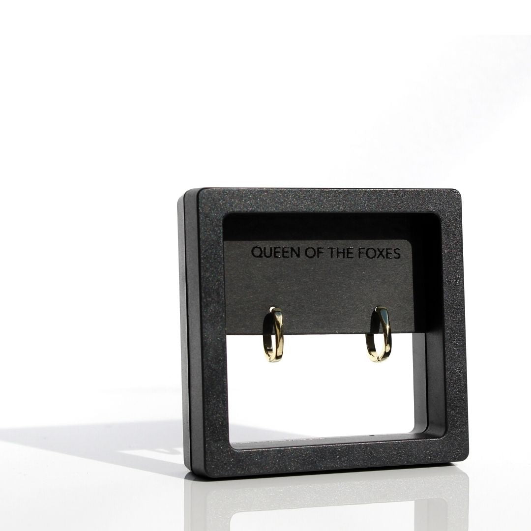 Petite Simple gold sleeper earrings displayed in black Queen of the Foxes packaging.