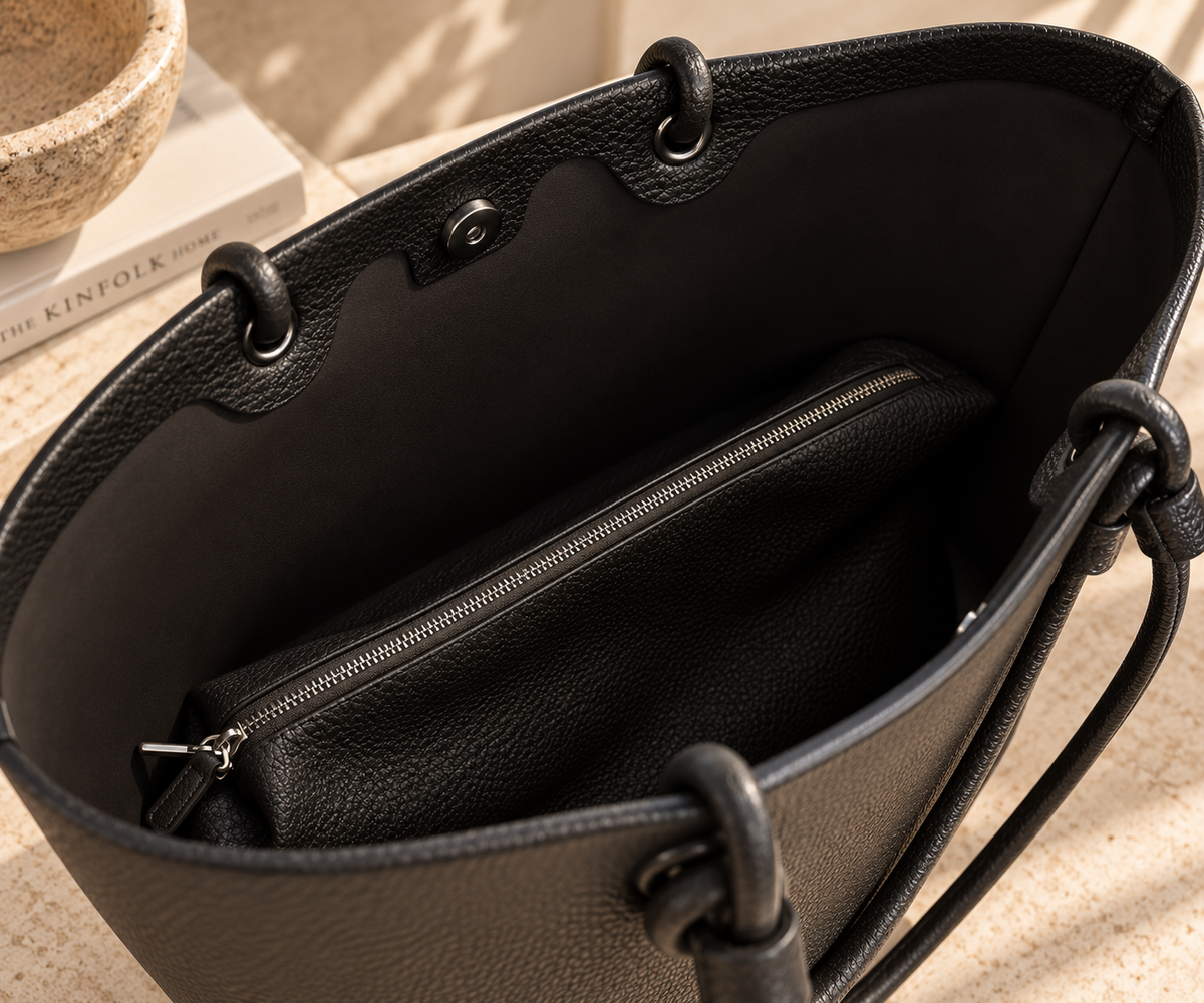Inside the spacious black Perfect Tote showing the magnetic closure and matching removable zippered dumpling bag.