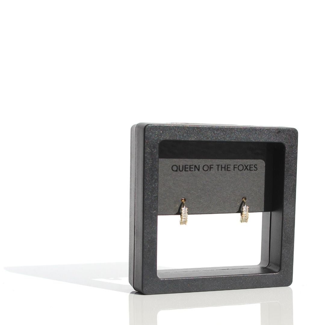 Gold Petite Marquise Sleeper earrings with clear zirconias displayed in black Queen of the Foxes packaging.