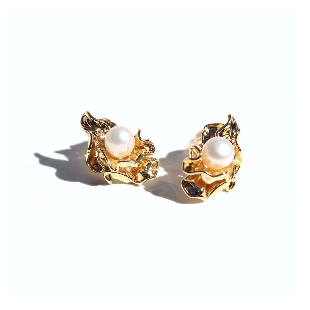 Pair of gold Ruched Pearl Earrings on a white background, featuring natural pearls in sculptural gold settings.